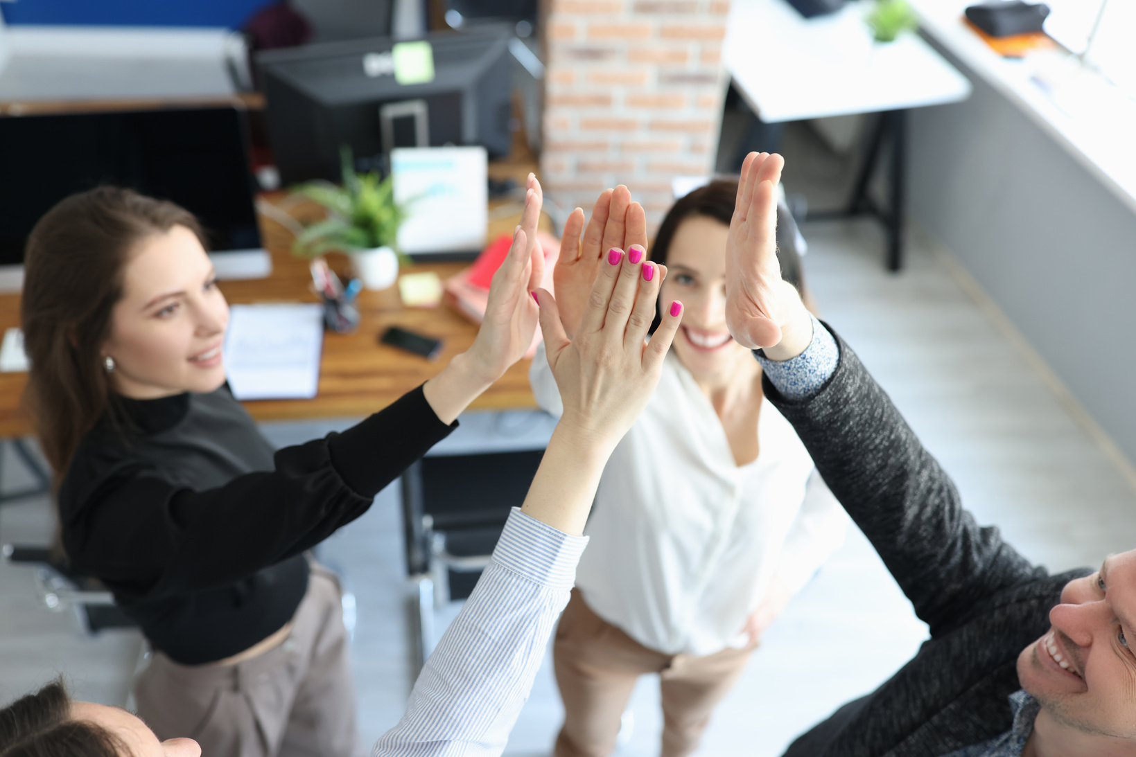 Business People Happily Give Each Other Five in Office